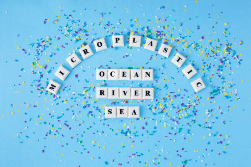 Word Microplastic Ocean River Sea Around Small Plastic Particles Blue Background 92397 140
